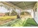 Large covered patio overlooking the green backyard, with a playground visible at 1117 Berkshire Rd, Daytona Beach, FL 32117