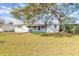 Spacious backyard featuring a well-maintained lawn and mature trees providing ample shade at 1117 Berkshire Rd, Daytona Beach, FL 32117