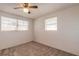 Bright bedroom featuring neutral carpet and large windows with blinds at 1117 Berkshire Rd, Daytona Beach, FL 32117