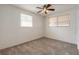 Light-filled bedroom showcasing neutral carpet and two windows with blinds at 1117 Berkshire Rd, Daytona Beach, FL 32117