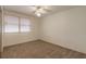 Bedroom featuring neutral carpet, ceiling fan and a large window at 1117 Berkshire Rd, Daytona Beach, FL 32117