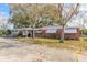 Charming single-story red brick home featuring a covered carport and well-maintained front yard at 1117 Berkshire Rd, Daytona Beach, FL 32117