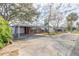 Charming single-story red brick home featuring a covered carport and well-maintained front yard at 1117 Berkshire Rd, Daytona Beach, FL 32117
