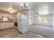 Bright eat-in kitchen featuring white cabinetry, updated floors, and modern lighting fixtures at 1117 Berkshire Rd, Daytona Beach, FL 32117