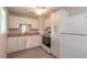 Traditional kitchen features white cabinetry, modern floors and sink, and white appliances at 1117 Berkshire Rd, Daytona Beach, FL 32117
