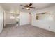 Bright living room with neutral carpet, ceiling fan, and large window to let in natural light at 1117 Berkshire Rd, Daytona Beach, FL 32117