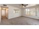 Cozy living room features plush carpeting, a ceiling fan, and a bright window at 1117 Berkshire Rd, Daytona Beach, FL 32117