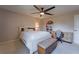 Cozy bedroom with a white bed frame, ceiling fan, and a wooden bench at 1120 Caldwell Ave, Orange City, FL 32763