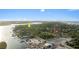 Aerial view of the property near the inlet, lighthouse and waterfront at 120 Beach St, Ponce Inlet, FL 32127