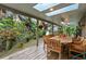 Covered back porch with skylights, ceiling fans and an outdoor dining table at 120 Beach St, Ponce Inlet, FL 32127