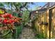 Stone walkway lined with colorful flowers and lush greenery at 120 Beach St, Ponce Inlet, FL 32127