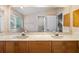 Bathroom featuring a double vanity, marble countertop, and large mirror at 120 Beach St, Ponce Inlet, FL 32127