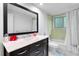Bathroom featuring vanity with dark wood drawers and a mirror at 120 Beach St, Ponce Inlet, FL 32127