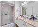 Updated bathroom with a glass-enclosed shower, granite vanity, and chrome hardware at 120 Beach St, Ponce Inlet, FL 32127