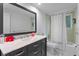 Bathroom featuring vanity with dark wood drawers and a mirror at 120 Beach St, Ponce Inlet, FL 32127