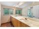Bathroom featuring a double vanity, large mirror, and walk-in shower at 120 Beach St, Ponce Inlet, FL 32127