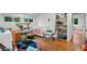 Bright playroom with hardwood floors, a white crib, and a bookcase at 120 Beach St, Ponce Inlet, FL 32127