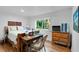 Bright bedroom with a wooden desk, hardwood floors, and a window overlooking the greenery at 120 Beach St, Ponce Inlet, FL 32127