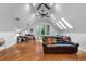 Bonus room with hardwood floors, a vaulted ceiling, and a leather couch at 120 Beach St, Ponce Inlet, FL 32127