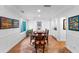 Formal dining room with hardwood floors, wainscoting, and elegant table with chairs at 120 Beach St, Ponce Inlet, FL 32127