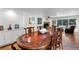 Elegant dining room with wood table, chairs, and hardwood floors leading into the living room at 120 Beach St, Ponce Inlet, FL 32127