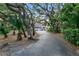 Long driveway leading up to a home surrounded by mature trees at 120 Beach St, Ponce Inlet, FL 32127