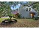 Exterior shot featuring a side view with an artistic fountain and lush landscaping at 120 Beach St, Ponce Inlet, FL 32127