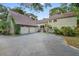 Inviting two-story home featuring an attached two-car garage, lush landscaping, and a well-maintained driveway at 120 Beach St, Ponce Inlet, FL 32127