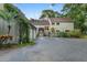 Inviting two-story home featuring an attached two-car garage, lush landscaping, and a well-maintained driveway at 120 Beach St, Ponce Inlet, FL 32127