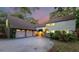 Charming two-story home featuring an attached two-car garage, lush landscaping, and a well-maintained driveway at 120 Beach St, Ponce Inlet, FL 32127