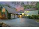 Inviting two-story home featuring an attached two-car garage, lush landscaping, and a well-maintained driveway at 120 Beach St, Ponce Inlet, FL 32127