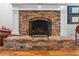 Close-up of a brick fireplace with decorative accents and a hearth at 120 Beach St, Ponce Inlet, FL 32127