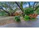 Landscaped front yard with a stone pathway, trees, and foliage at 120 Beach St, Ponce Inlet, FL 32127