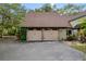 Attached two-car garage with a paved driveway and mature landscaping at 120 Beach St, Ponce Inlet, FL 32127