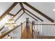 Bright hallway featuring wood floors, vaulted ceilings with exposed beams, and a chandelier at 120 Beach St, Ponce Inlet, FL 32127