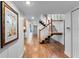 Hallway showcasing hardwood floors, white wainscoting, and a staircase leading to the upper level at 120 Beach St, Ponce Inlet, FL 32127