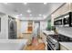 Kitchen area with stainless steel appliances, hardwood floors, and garden window at 120 Beach St, Ponce Inlet, FL 32127