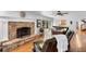 Cozy living room featuring a brick fireplace, sliding glass doors, and hardwood floors at 120 Beach St, Ponce Inlet, FL 32127