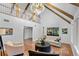 Open living area with vaulted ceilings, wood beams, and a view of the second story landing at 120 Beach St, Ponce Inlet, FL 32127