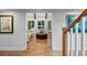 Bright living room with hardwood floors, beamed ceilings, large windows, and an adjacent sitting area at 120 Beach St, Ponce Inlet, FL 32127