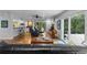 Open concept living area with hardwood floors, a bar area, a brick fireplace, and a view of the pool at 120 Beach St, Ponce Inlet, FL 32127