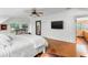Bright main bedroom with wood floors, flat screen tv, and an ensuite bathroom at 120 Beach St, Ponce Inlet, FL 32127
