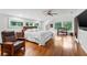 Spacious main bedroom with wood floors, natural light, ceiling fan and bench seating at 120 Beach St, Ponce Inlet, FL 32127
