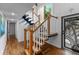 Beautiful staircase featuring hardwood steps, a wooden railing, and a custom door with palm tree design at 120 Beach St, Ponce Inlet, FL 32127