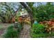 Stone walkway lined with colorful flowers and lush greenery at 120 Beach St, Ponce Inlet, FL 32127