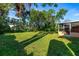 Expansive backyard with lush grass and mature trees, ideal for outdoor enjoyment at 1216 Sunland Rd, Daytona Beach, FL 32114