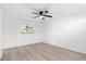 Neutral bedroom with ceiling fan and light wood flooring at 1216 Sunland Rd, Daytona Beach, FL 32114