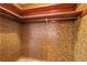 A cozy closet space is shown with brown walls and simple wooden shelves and a metal hanging bar at 1216 Sunland Rd, Daytona Beach, FL 32114