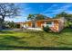 Street view of a cozy single-story home with a lush green lawn and mature trees at 1216 Sunland Rd, Daytona Beach, FL 32114