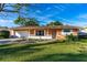 Charming single-story home with a well-manicured lawn and attached two car garage, offering suburban appeal at 1216 Sunland Rd, Daytona Beach, FL 32114